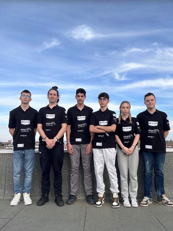 Six ROMSPACE teammates standing together outdoors in their mission shirts